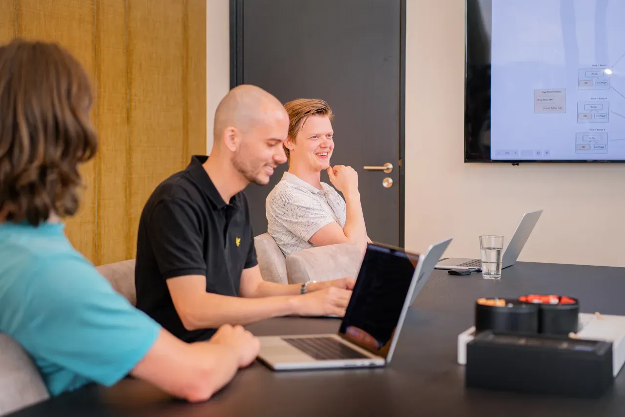 Drie collega's van Meierij IT werken samen aan een tafel in de vergaderruimte